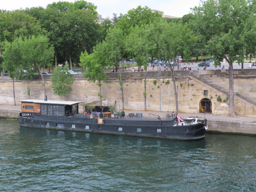 A fair number of old freight boats that have been converted to homes are moored along the Seine in Paris.