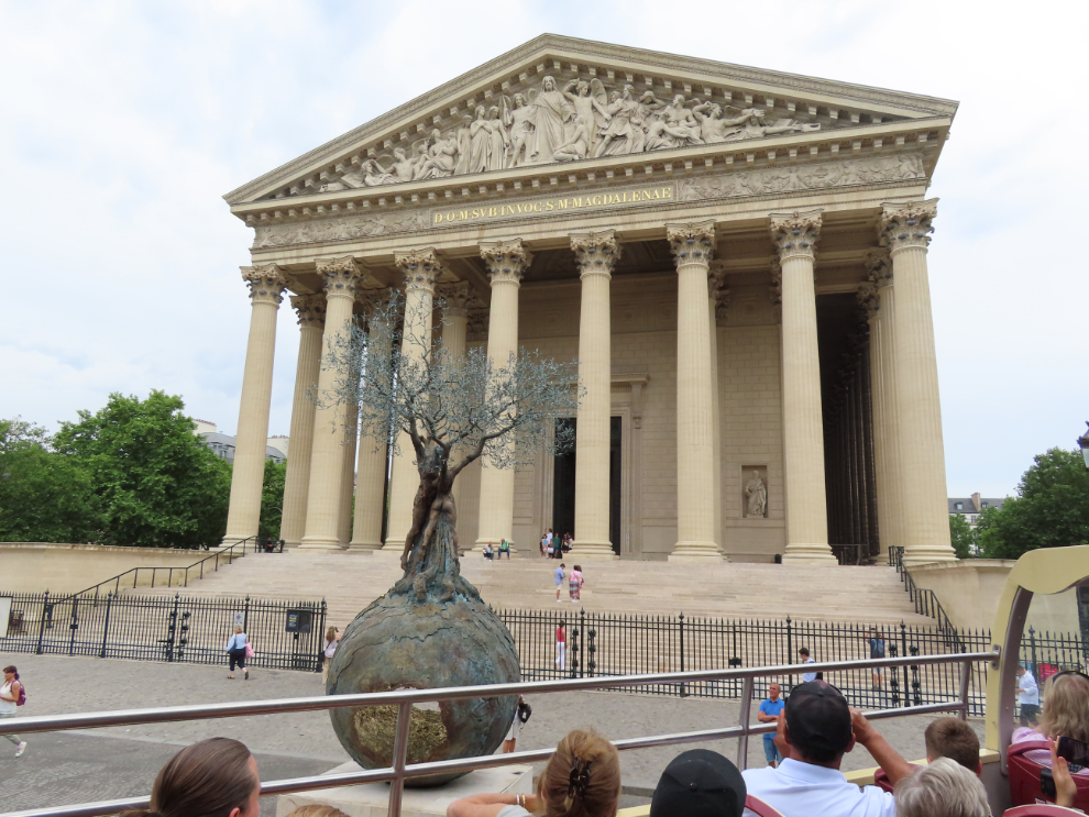 Touring Paris by open-top bus. The Church of Saint Mary Magdalene (La Madeleine) is a Catholic parish church built in 1828.