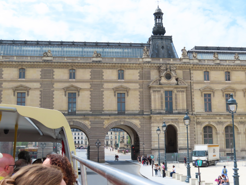 Touring Paris by open-top bus - leaving the courtyard of the Louvre.