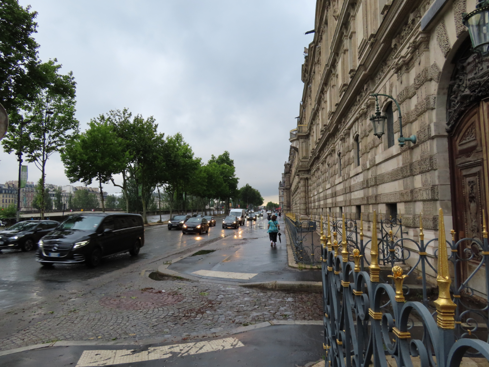 Walking along Voie Georges Pompidou, with the palace walls of the Louvre dominating.
