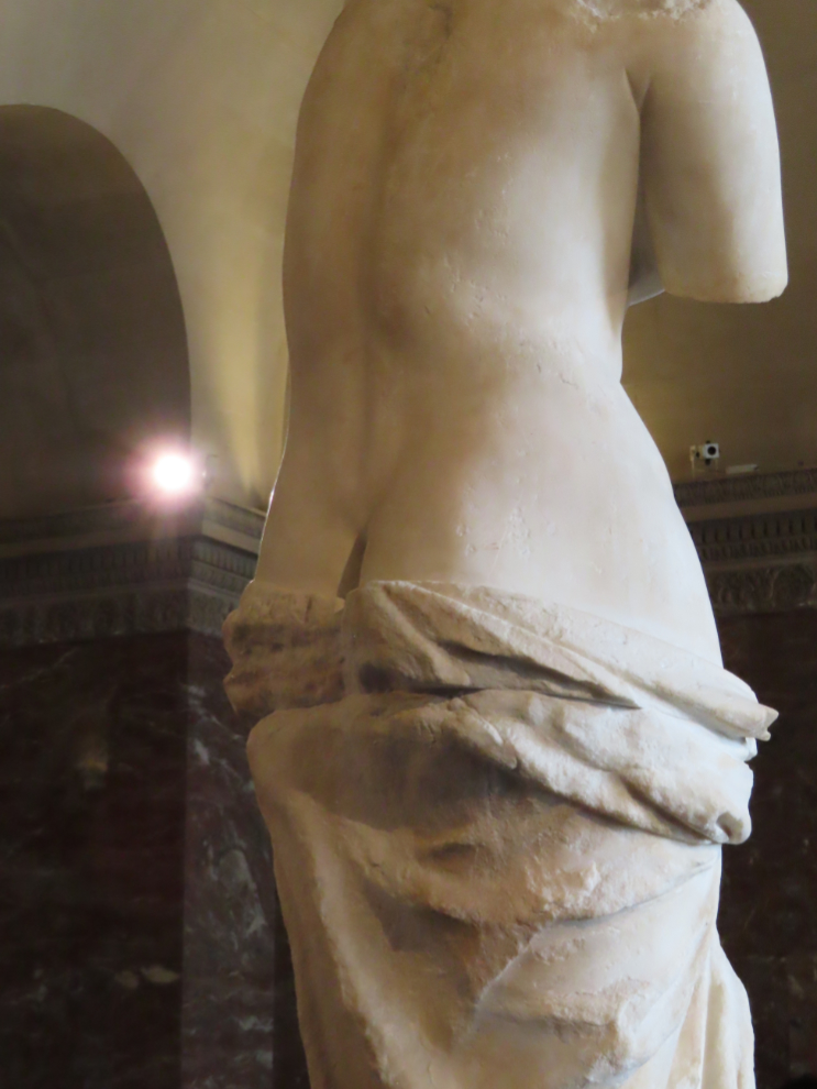 The rough back of Aphrodite, commonly called Venus de Milo, at the Louvre Museum in Paris.
