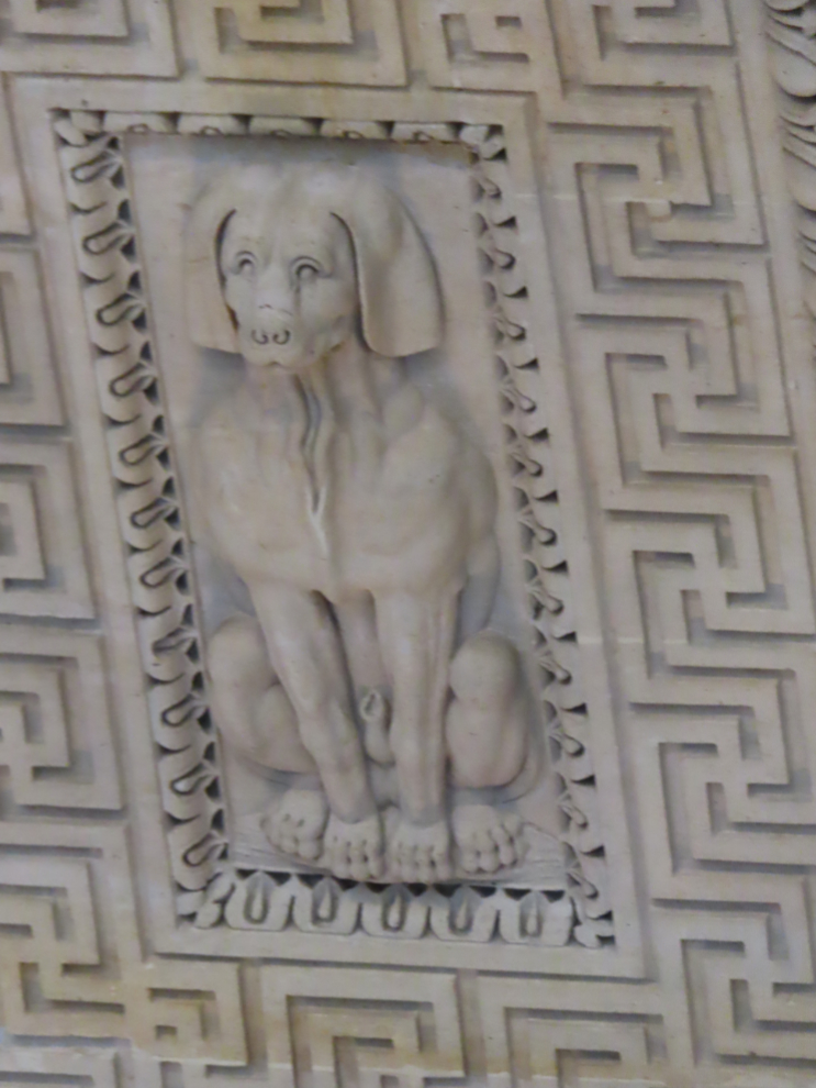A dog sculpture on a ceiling at the Louvre Museum in Paris.