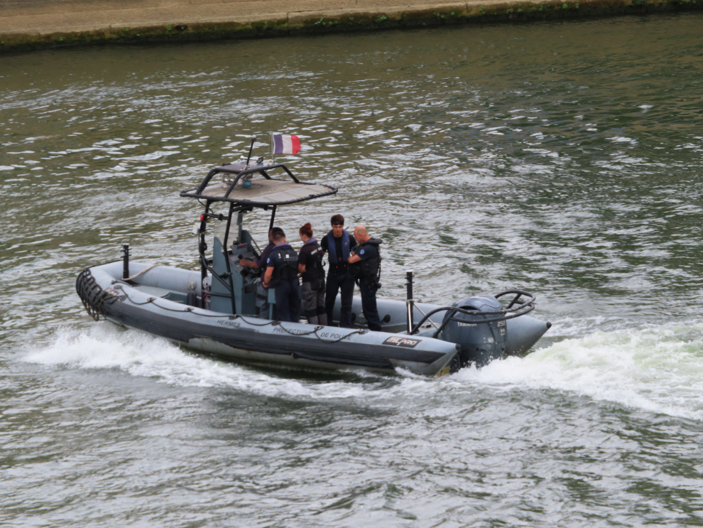 A police boat passes the Pont Neuf in Paris.