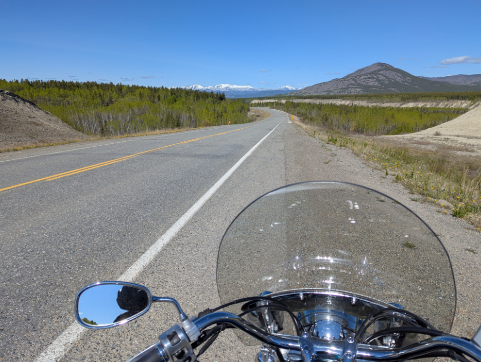 The view from my motorcycle, looking up the Alaska Highway west of Whitehorse.