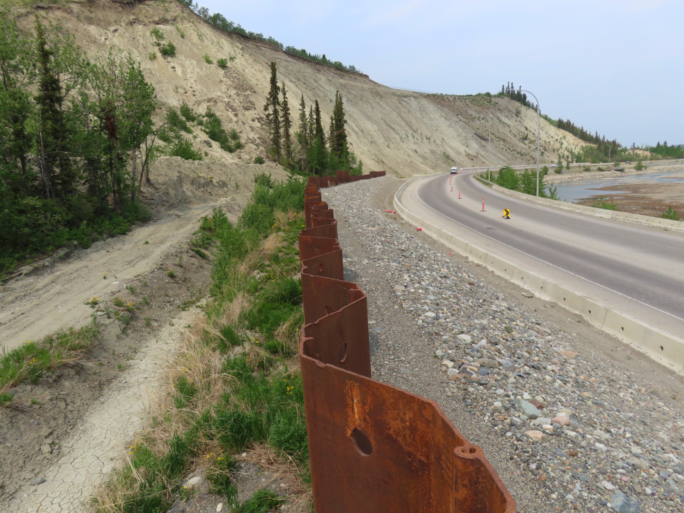 The metal sheet piling wall that was installed along Robert Service Way in 2022 as a slide barrier.