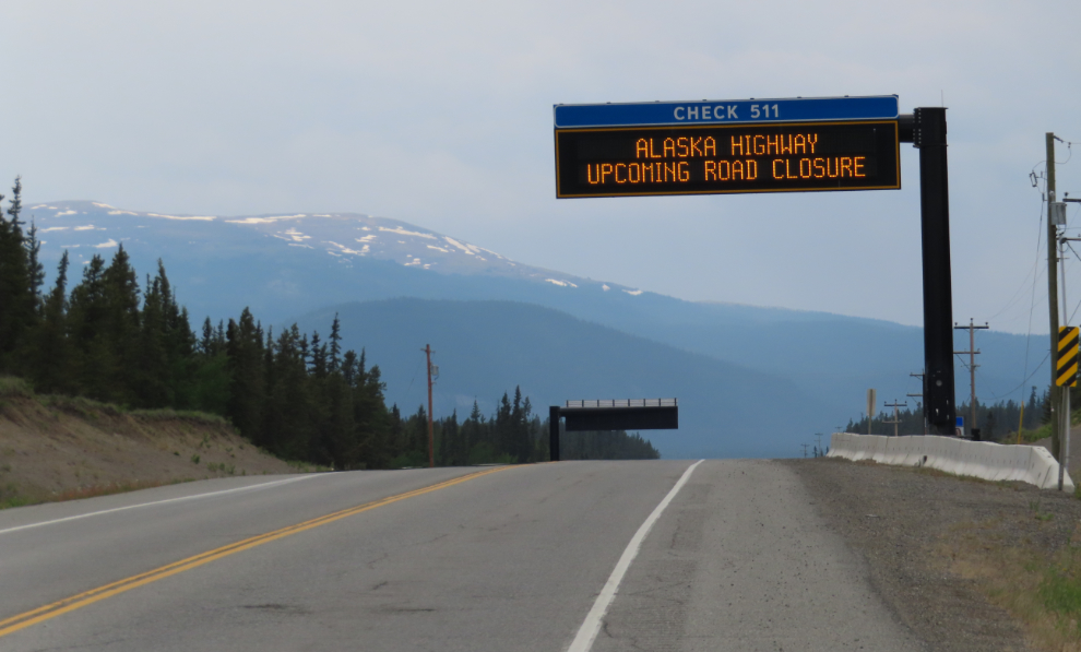 Highway conditions sign warns of an upcoming closure of the Alaska Highway.