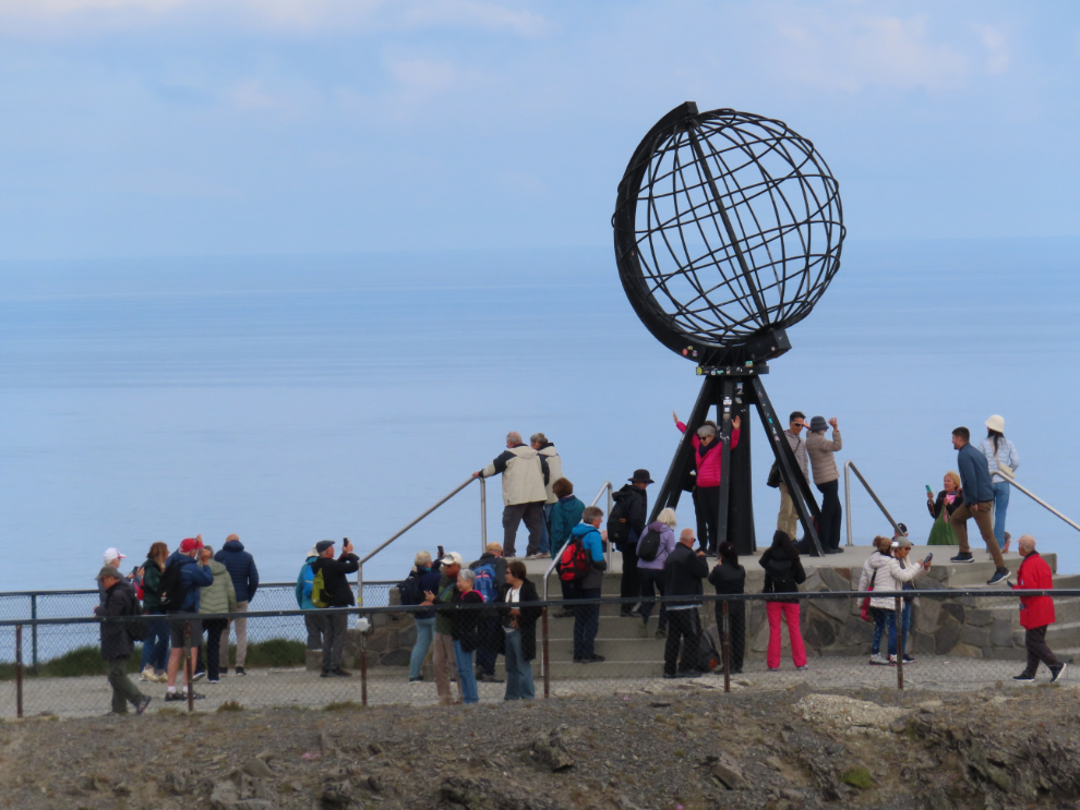 A crowd of tourists at the globe at Nordkapp (North Cape), Norway.