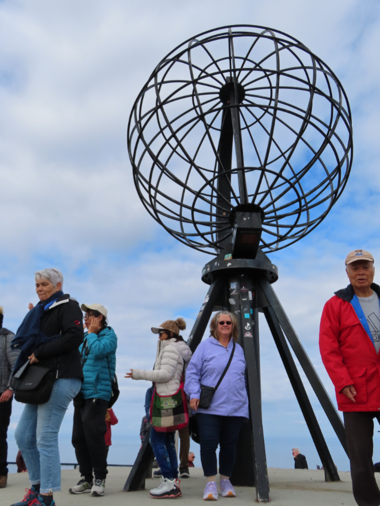 Cathy Dyson among the crowd of tourists at the globe at Nordkapp (North Cape), Norway.