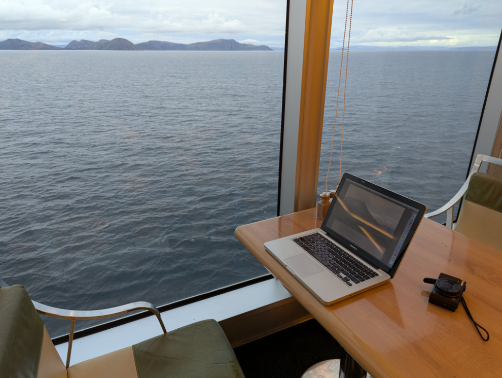 My early-morning blog-writing station in The Lido buffet area on Deck 9 of the Holland America cruise ship Nieuw Statendam, off the coast near Hammerfest, Norway.