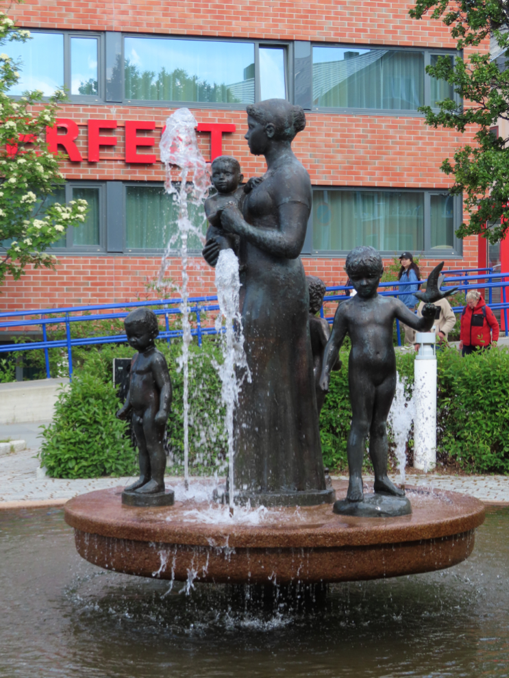 The beautiful fountain 'Mother and Children,' created by Onulf Bast, in a park at Hammerfest, Norway.