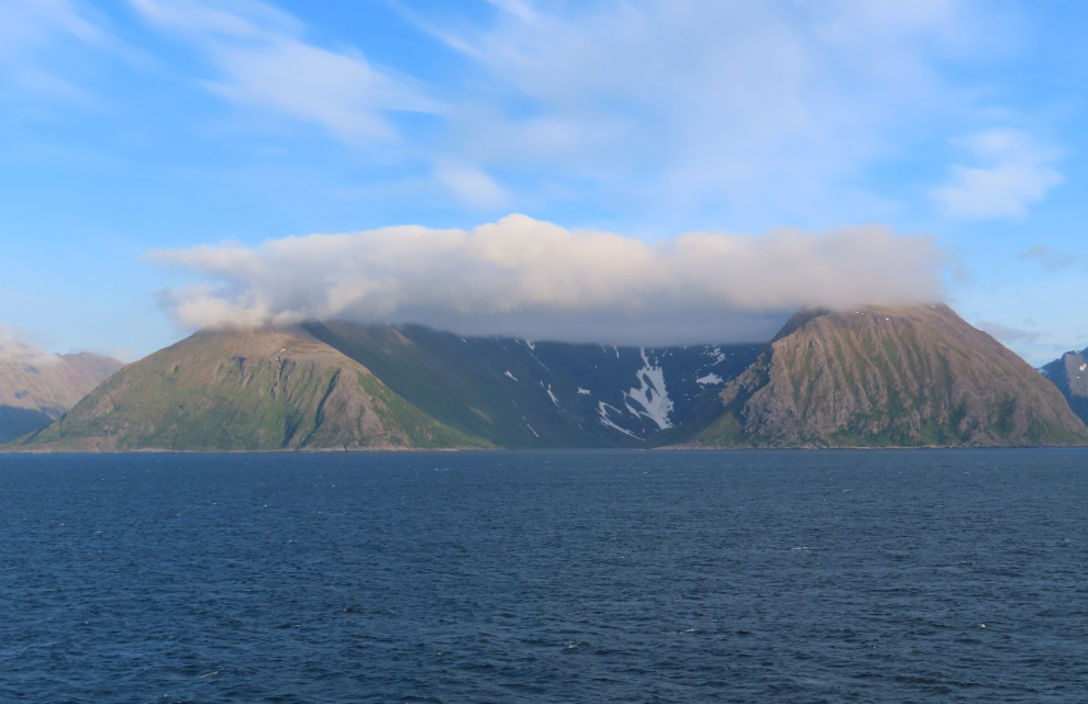 Mountains and clouds along the coast south of Hammerfest, Norway.