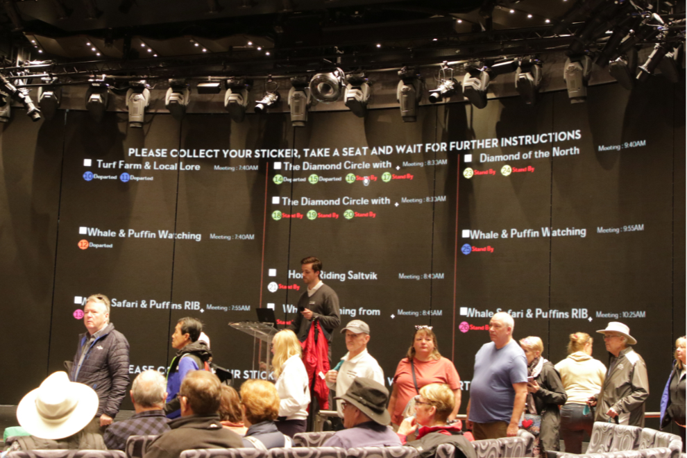 Gathering for an excursion at Husavik, Iceland, in the main theatre of the Holland America cruise ship Nieuw Statendam.