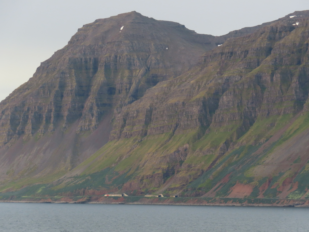 Highway tunnels along the north coast of Iceland, seen from the sea.