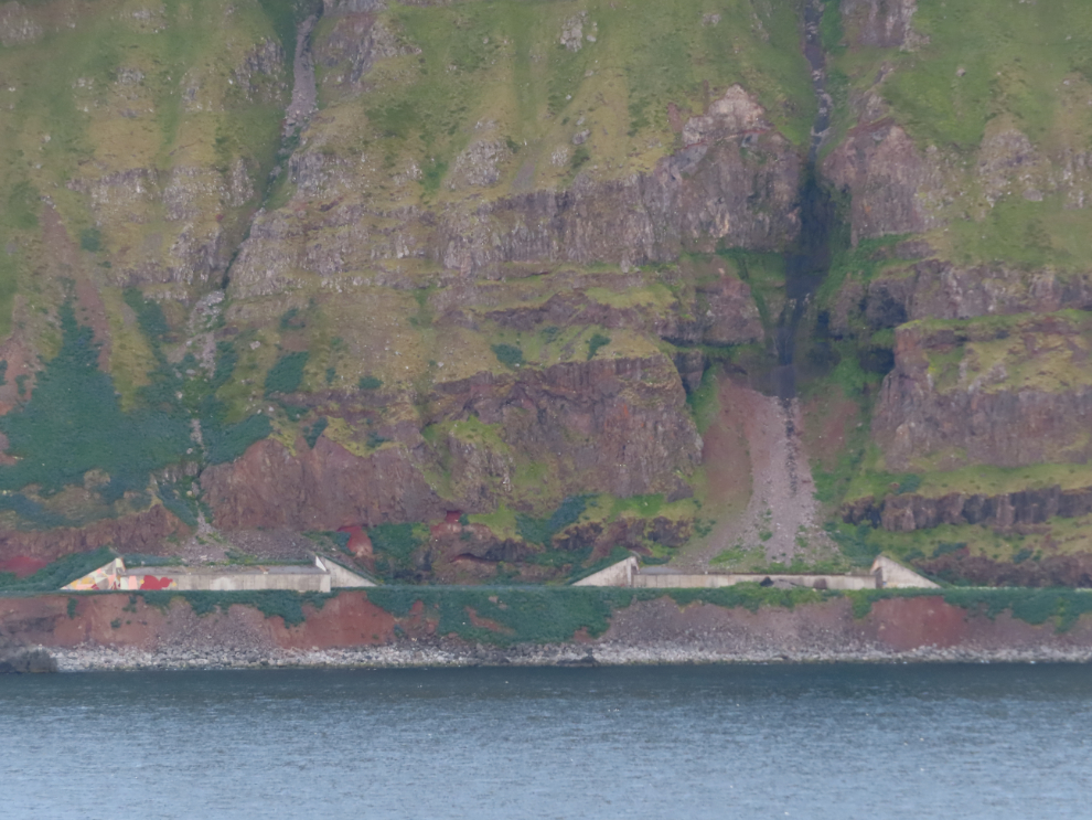 Highway avalanche sheds along the north coast of Iceland, seen from the sea.