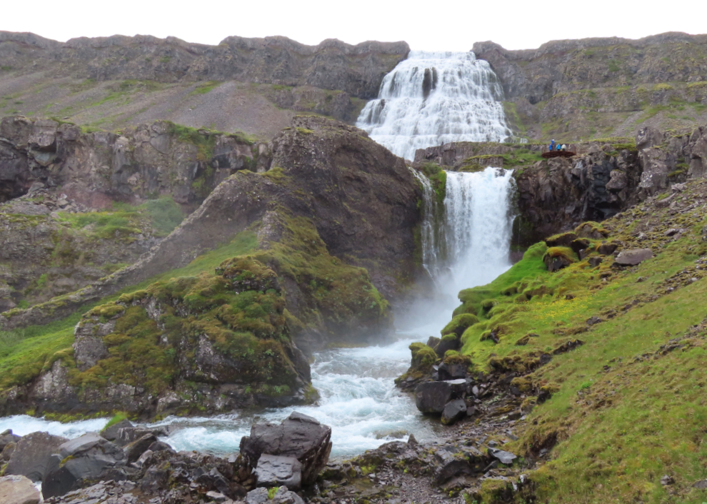 The huge upper waterfall is the Dynjandi waterfall in Iceland.