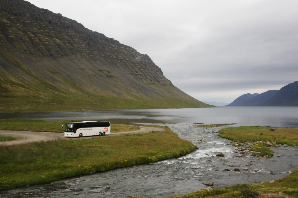 A tour bus in the parking area at the Dynjandi waterfall in Iceland.