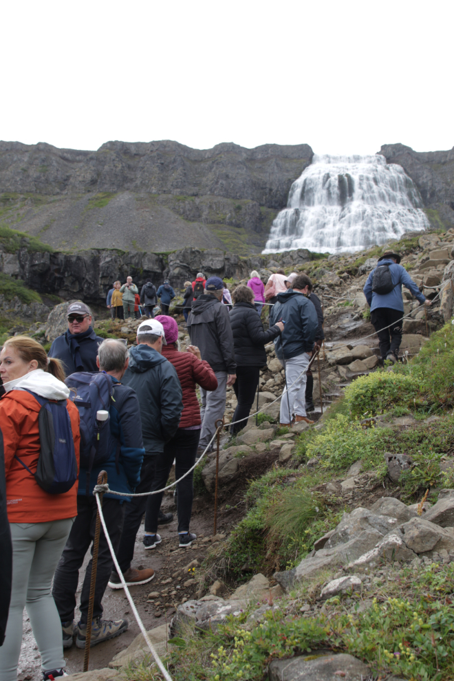 Climbing to the huge waterfall Dynjandi in Iceland.