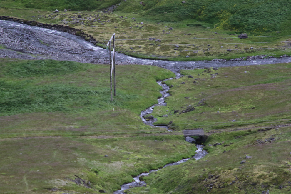 A piece of the old road with a concrete bridge along the highway between  Isafjordur and Dynjandi, Iceland.
