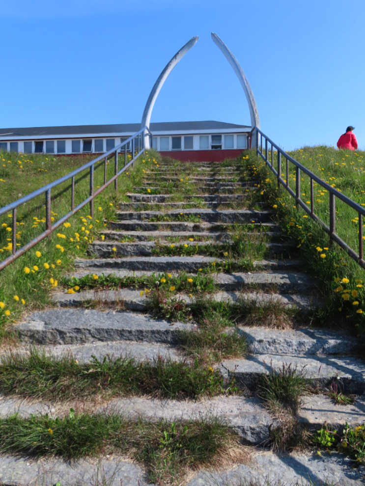 A whale-jaw arch at the top of stone stairs at Paamiut, Greenland.