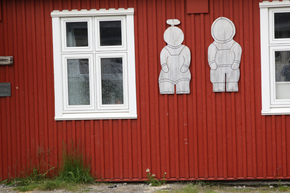 Cutouts of Inuit people on a building at Qaqortoq, Greenland.
