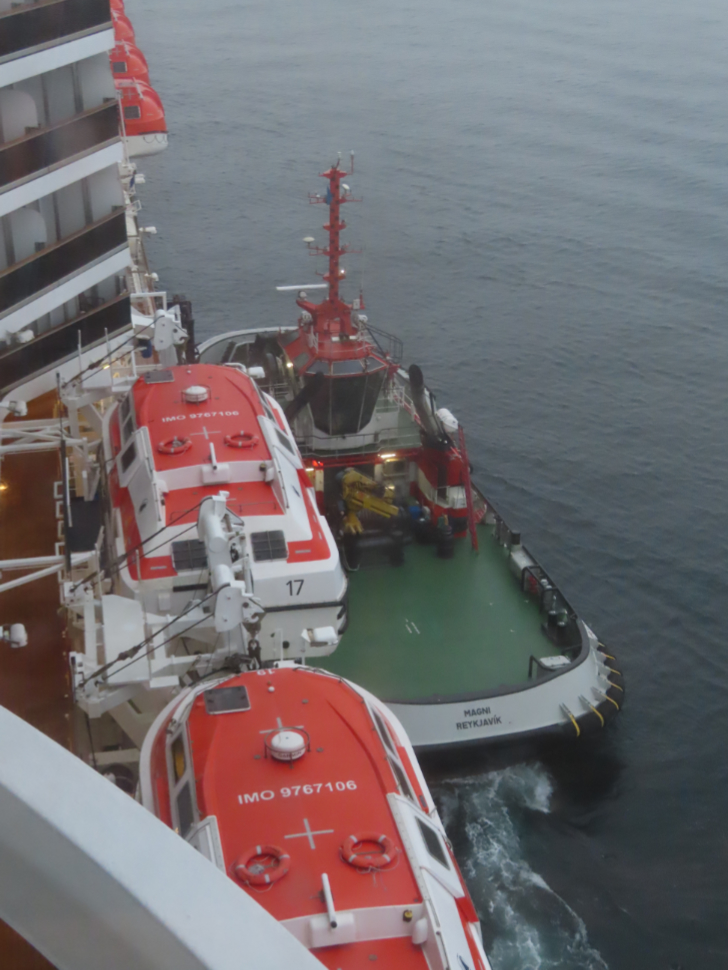 The tug Magni drops a pilot to the Holland America cruise ship Nieuw Statendam as she approaches foggy Reykjavik, Iceland.