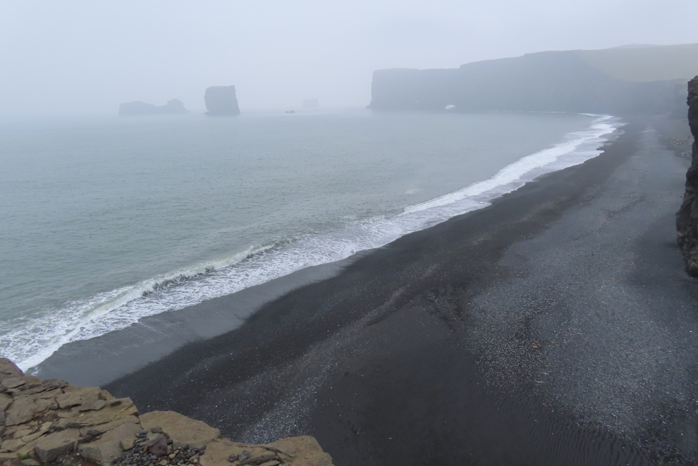 The black sand beach at Dyrholaey on Iceland's South Coast, in heavy fog and volcanic smoke.