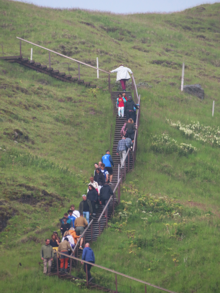 Climbing several hundred stairs to see the waterfall Skogafoss on Iceland's South Coast, from the top.