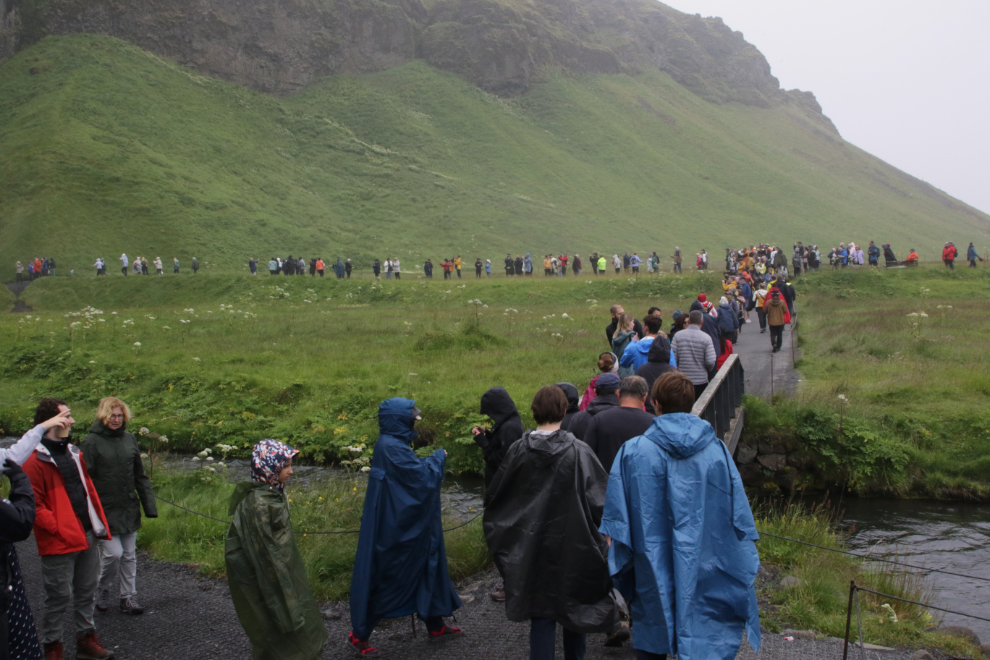 Crowds of people the waterfall Seljalandsfoss, Iceland.
