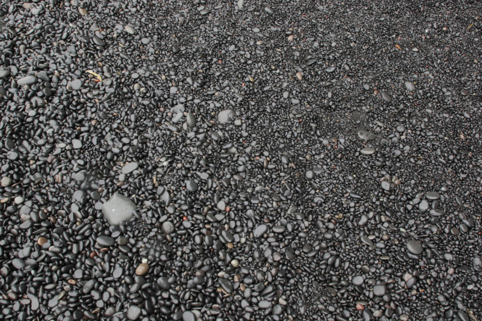 Polished black stones and pebbles at Reynisfjara, Iceland, often termed a black sand beach.
