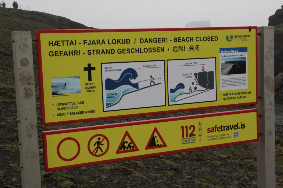 Warning sign at Dyrholaey on Iceland's South Coast, in heavy fog and volcanic smoke.