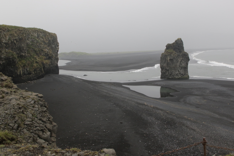 An impressive view at Dyrholaey on Iceland's South Coast, in heavy fog and volcanic smoke. 