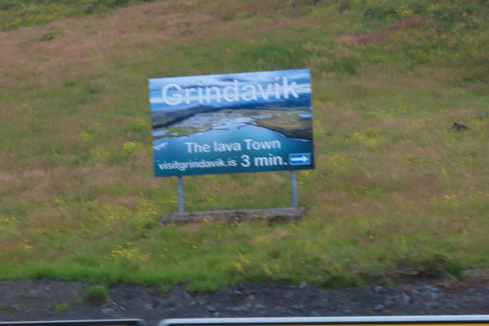 Roadside sign advertising 'Grindavík - the lava town,' Iceland.