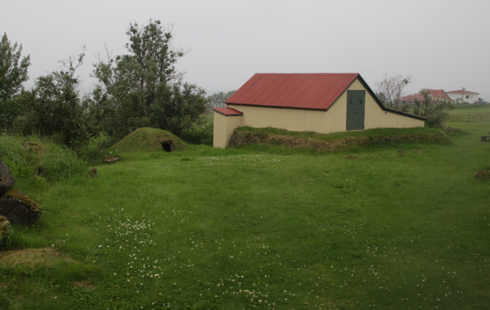 Old farm buildings on the foggy coast south of Reykjavik, Iceland.
