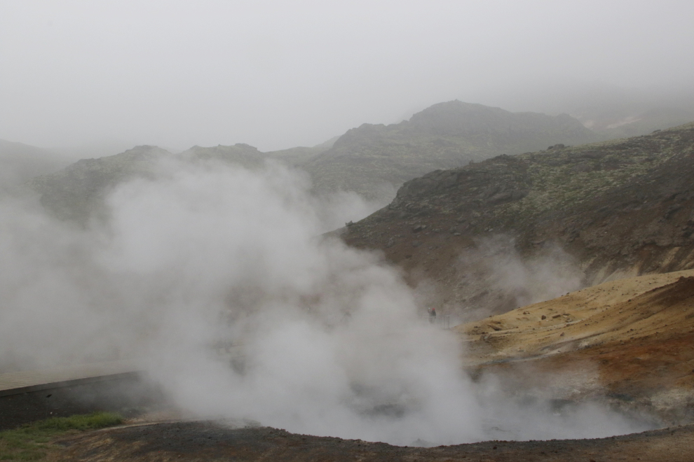 The Seltun Geothermal Area on the Reykjanes Peninsula, Iceland, with steam and heavy volcanic smoke.