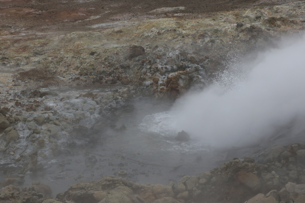 Gunnuhver Hot Springs, Iceland, with boiling water, steam and heavy volcanic smoke.