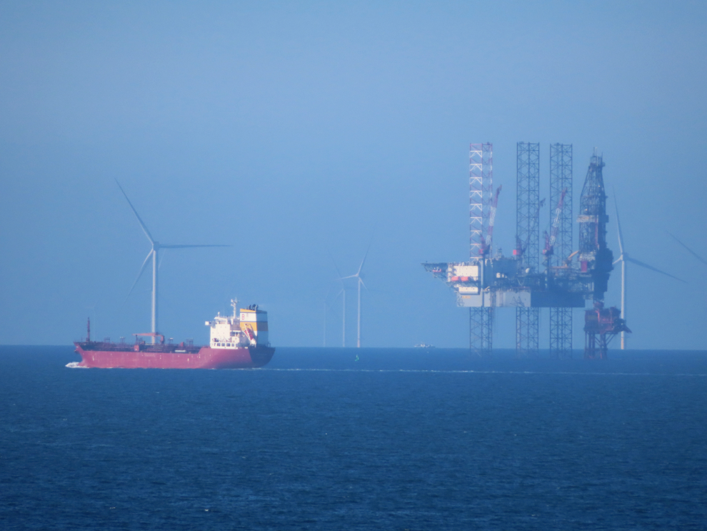 A North Sea drill rig and wind turbines.