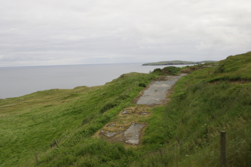 An old section of road along the coast in southern Shetland.