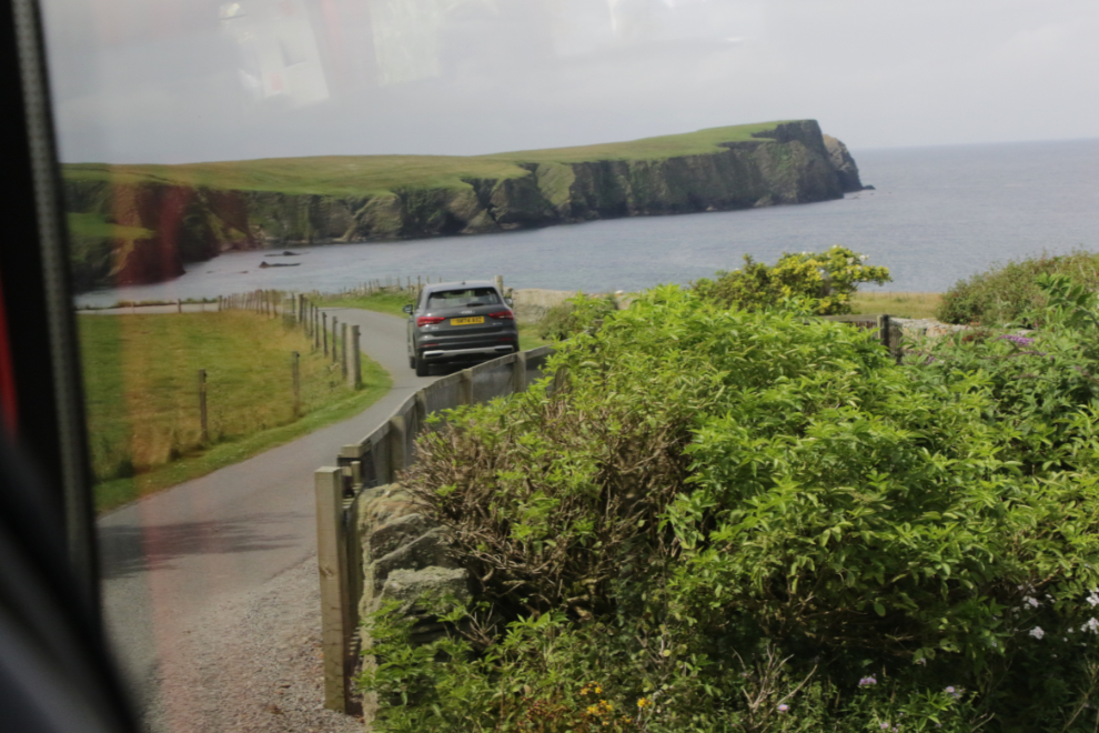 Driving towards St. Ninian Isle on a one-lane road in Shetland.