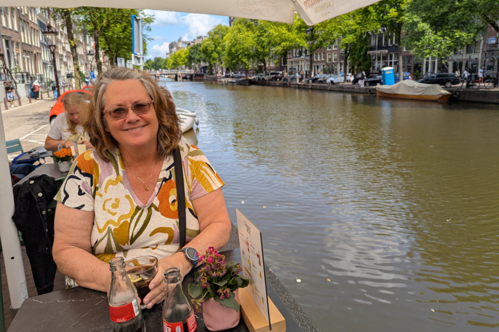 My wife having lunch at a cafe beside a canal in Amsterdam.