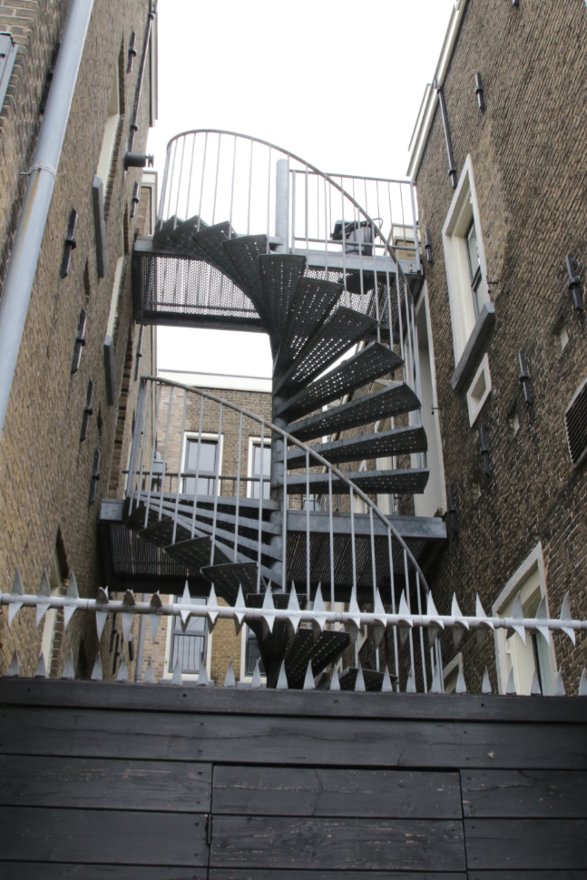Security fence and circular metal stairs at Gouda, South Holland, the Netherlands.