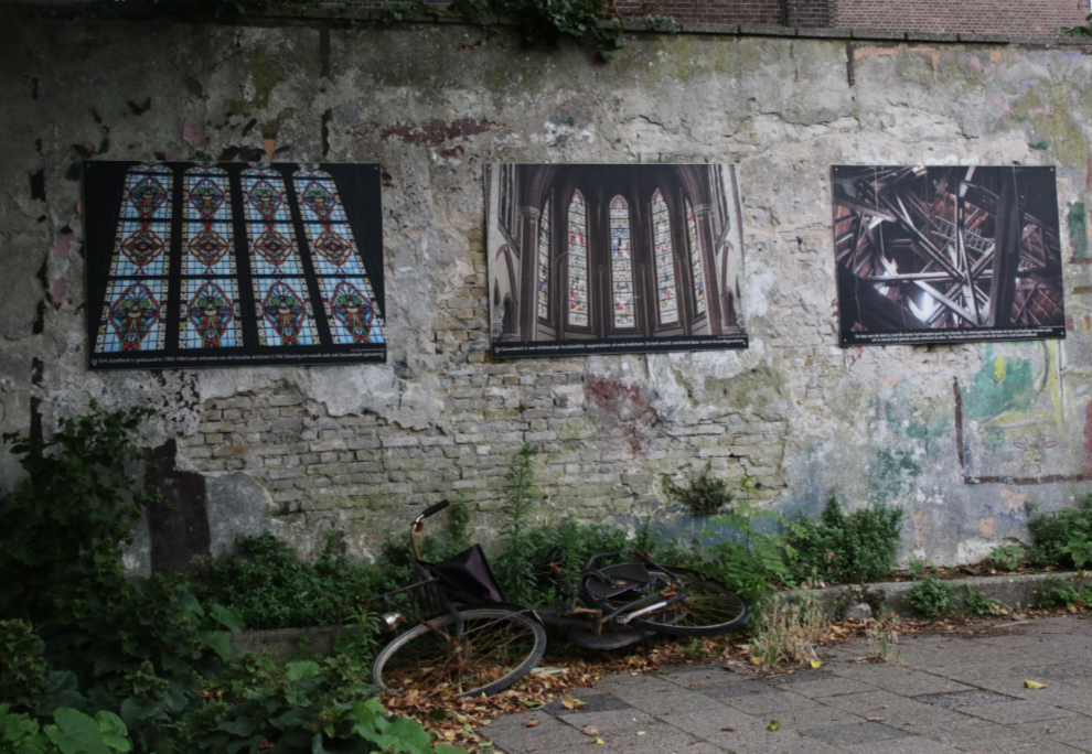 A neglected photo display behind a church at Gouda, South Holland, the Netherlands.