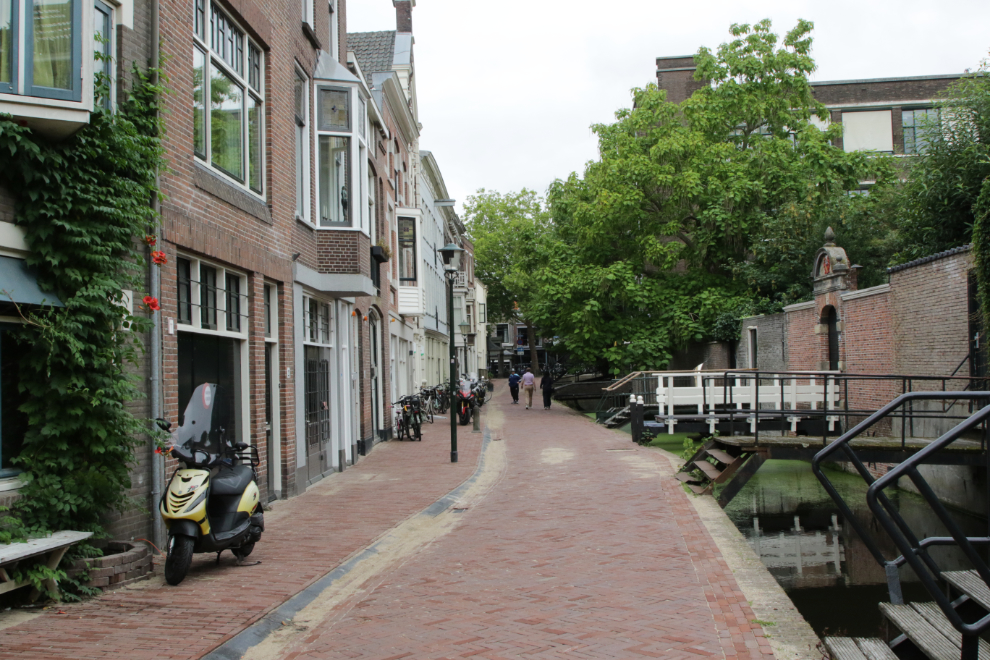 A street scene with a small canal at Gouda, South Holland, the Netherlands.
