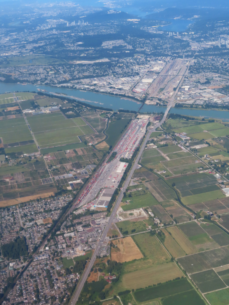 An aerial view of the huge rail yard and Intermodal Facility at Pitt Meadows, and the PortCoquitlam railyard beyond.