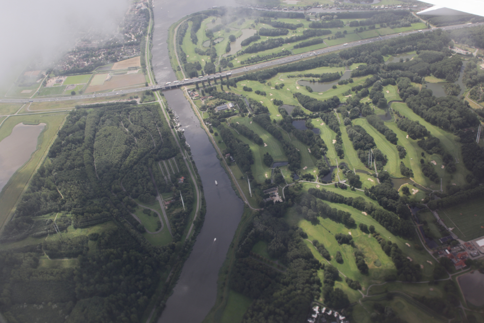 Taxiing off from Amsterdam Airport Schiphol (AMS) in an Icelandair Boeing 767, with golf corses below.