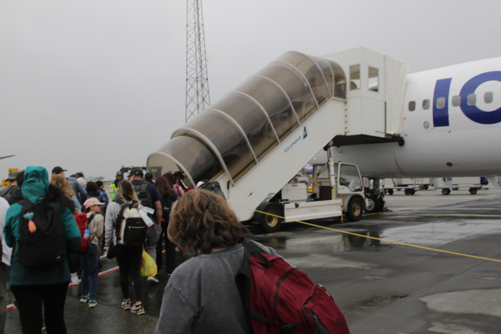 Boarding an aircraft on the ramp at rainy Reykjavík–Keflavík Airport (KEF).