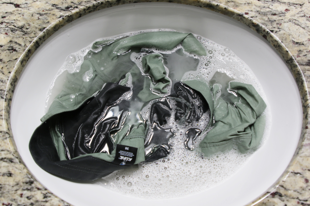 Washing my KUHL Resistor Lite Chino shorts in a bathroom sink.