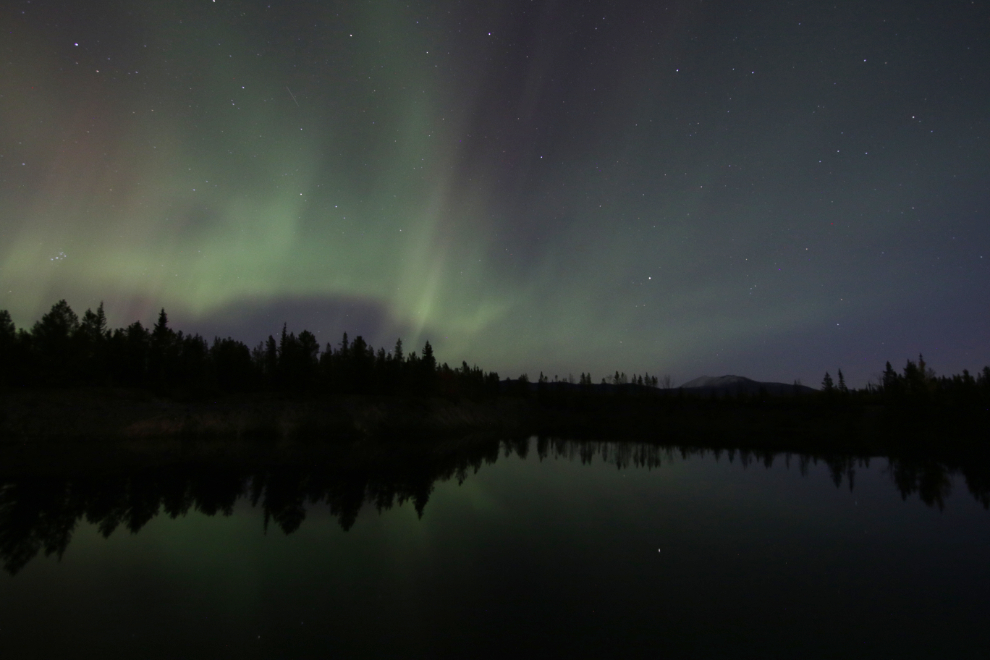 Northern Lights over a flooded copper mining pit at Whitehorse, Yukon.
