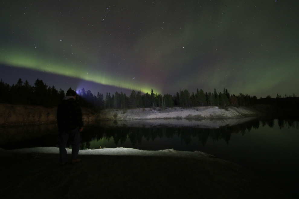The aurora borealis over a flooded copper mining pit at Whitehorse, Yukon.