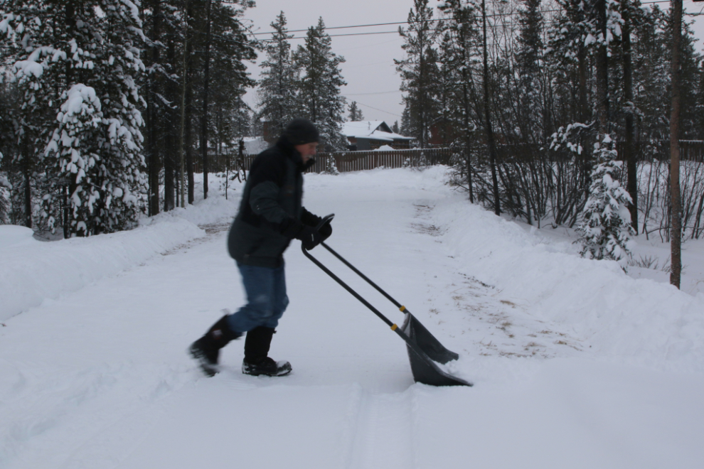 Shovelling/scooping the snow off our long driveway by hand.
