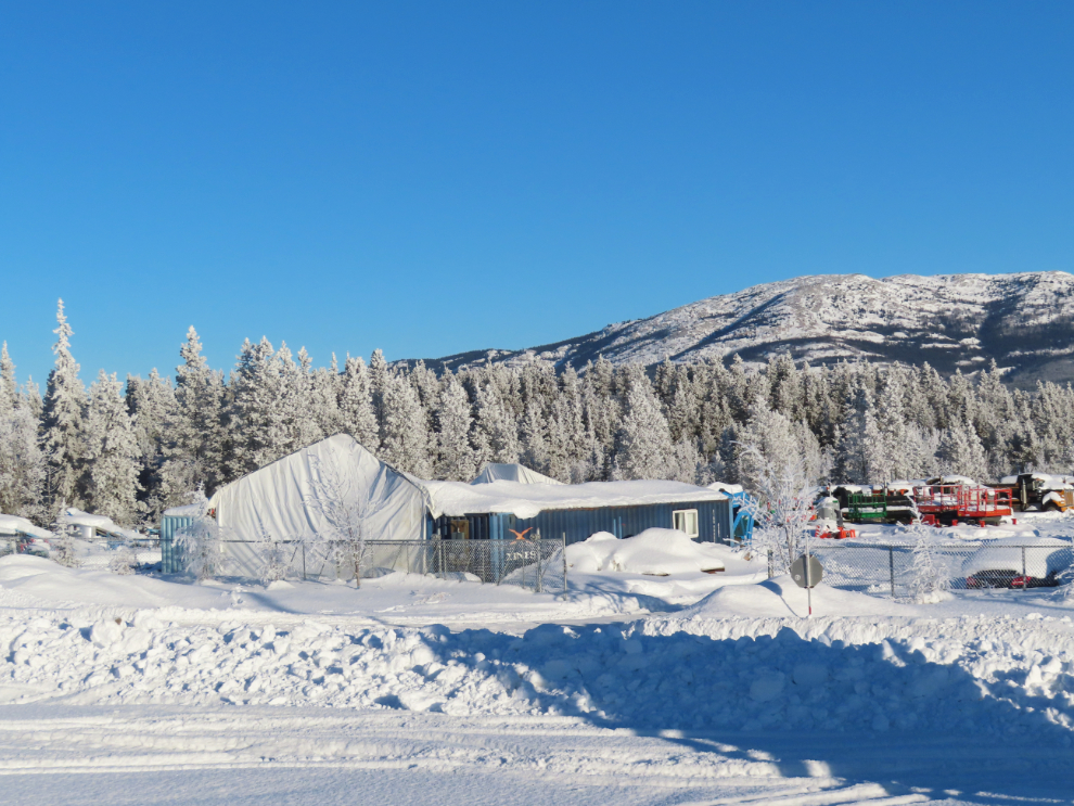 A large storage tent crushed by heavy snow at Whitehorse.